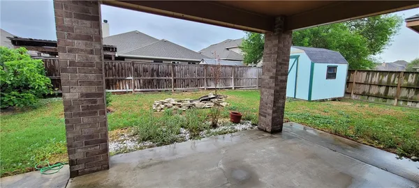 a view of a back yard with a patio