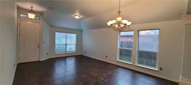 a view of a room with wooden floor and chandelier