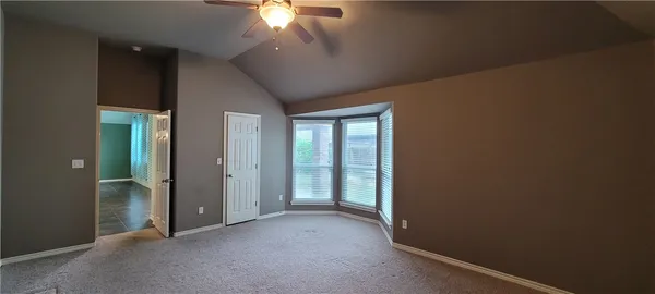 an empty room with a empty space and a ceiling fan