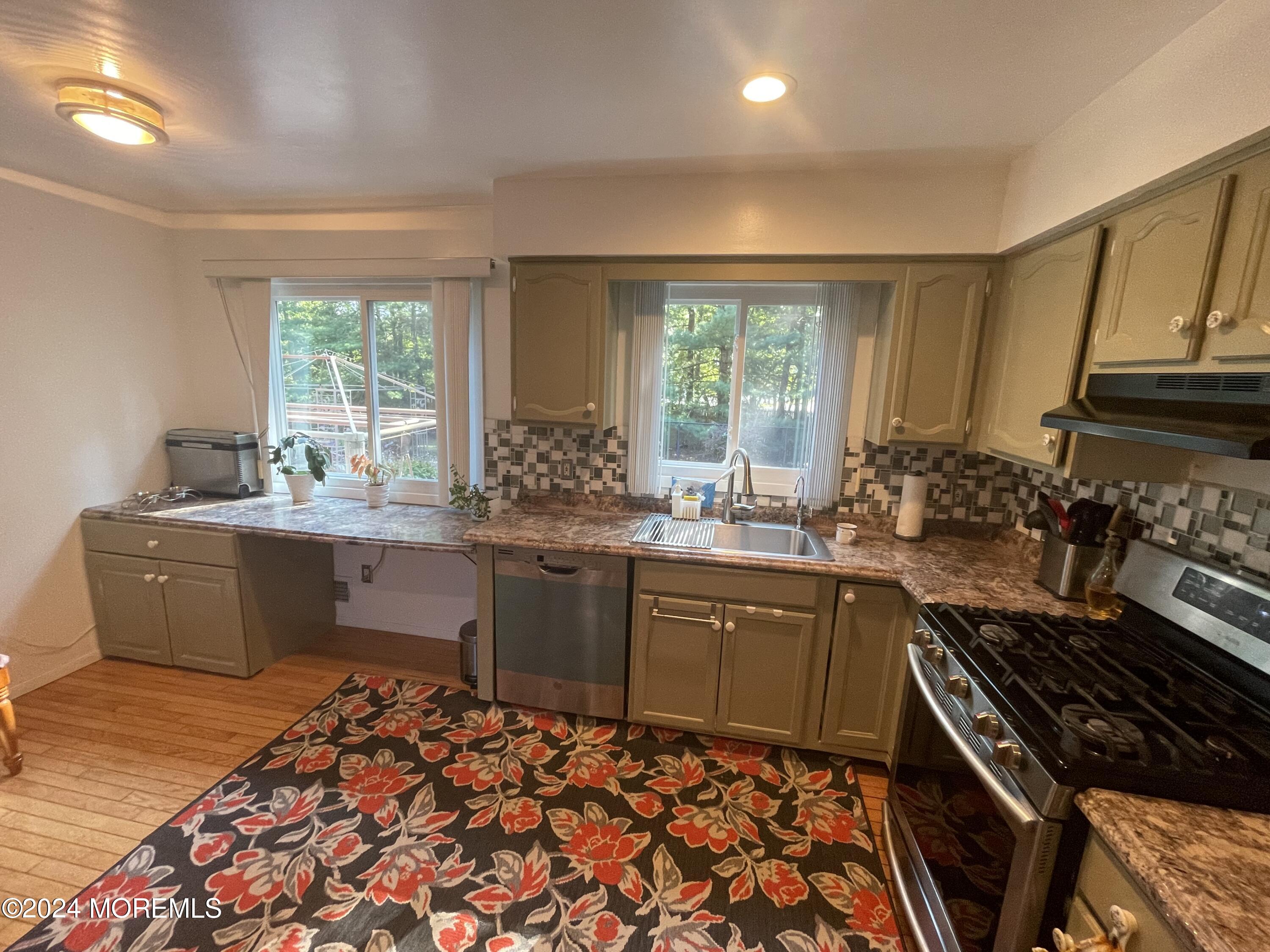 4 Rimwood Lane Howell, NJ 07731 - Photo 12 of 44 a kitchen with a sink stove and cabinets