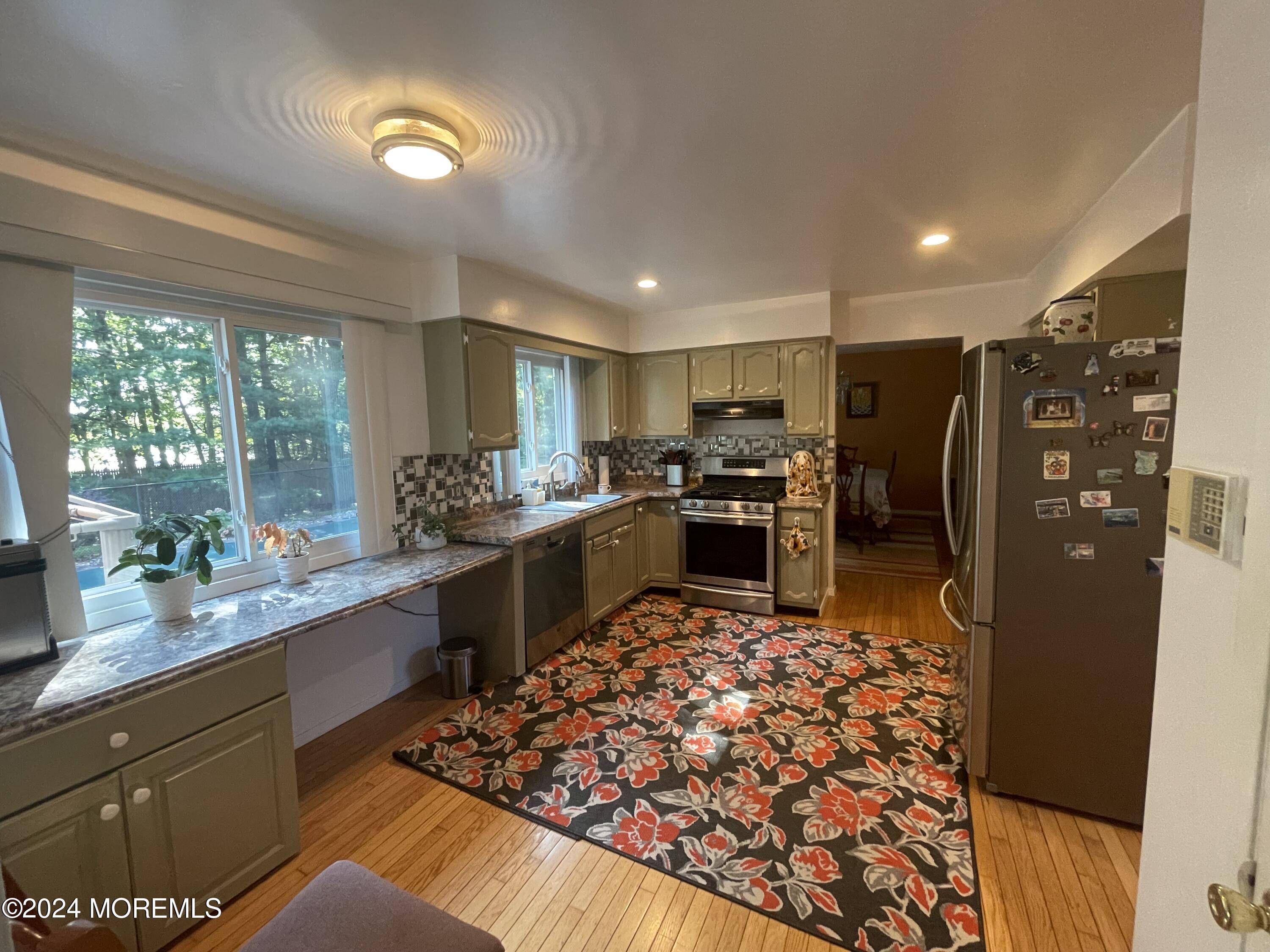 4 Rimwood Lane Howell, NJ 07731 - Photo 13 of 44 a kitchen with stainless steel appliances granite countertop a sink stove and refrigerator