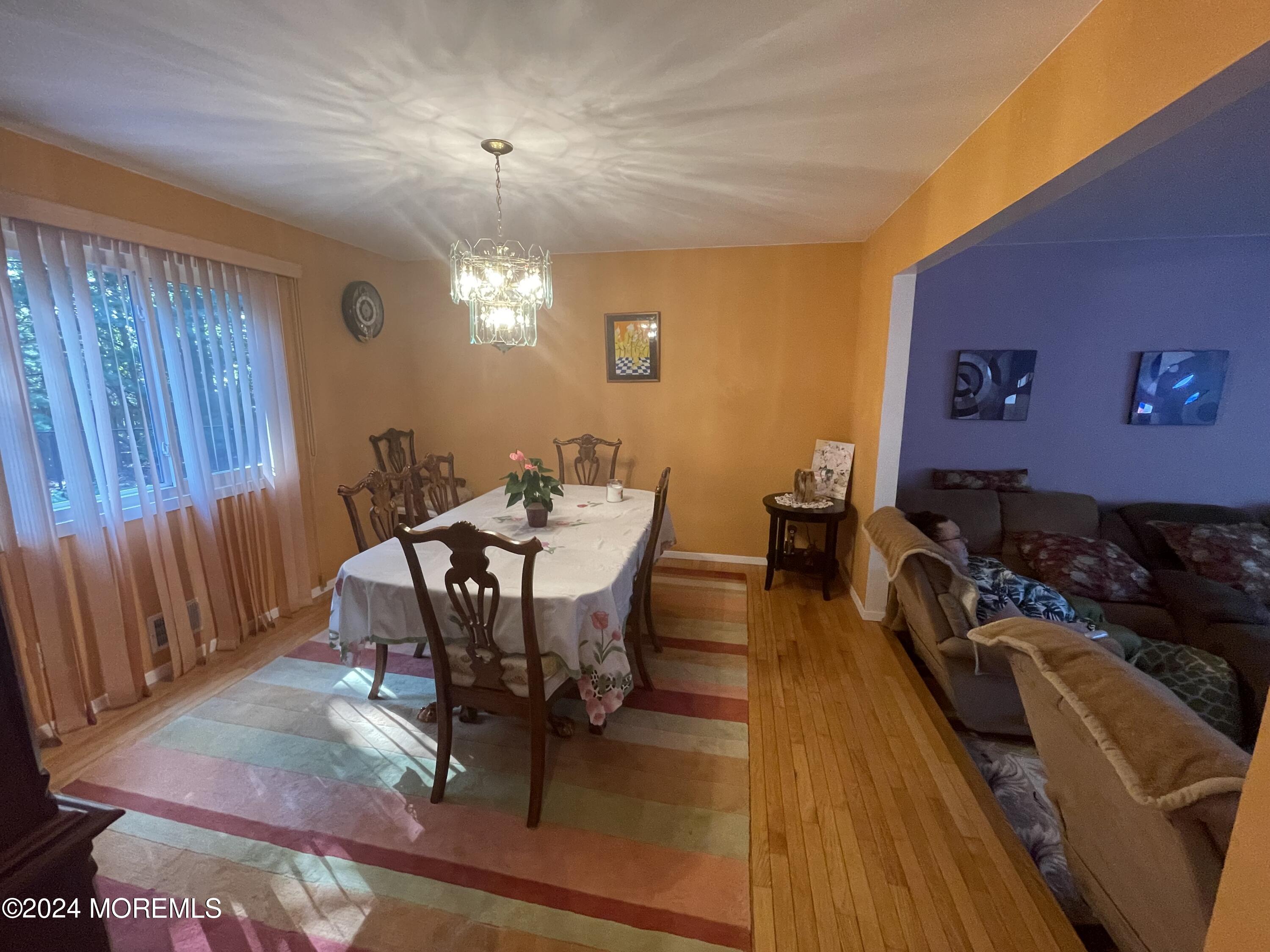4 Rimwood Lane Howell, NJ 07731 - Photo 15 of 44 a living room with furniture dining table and a chandelier
