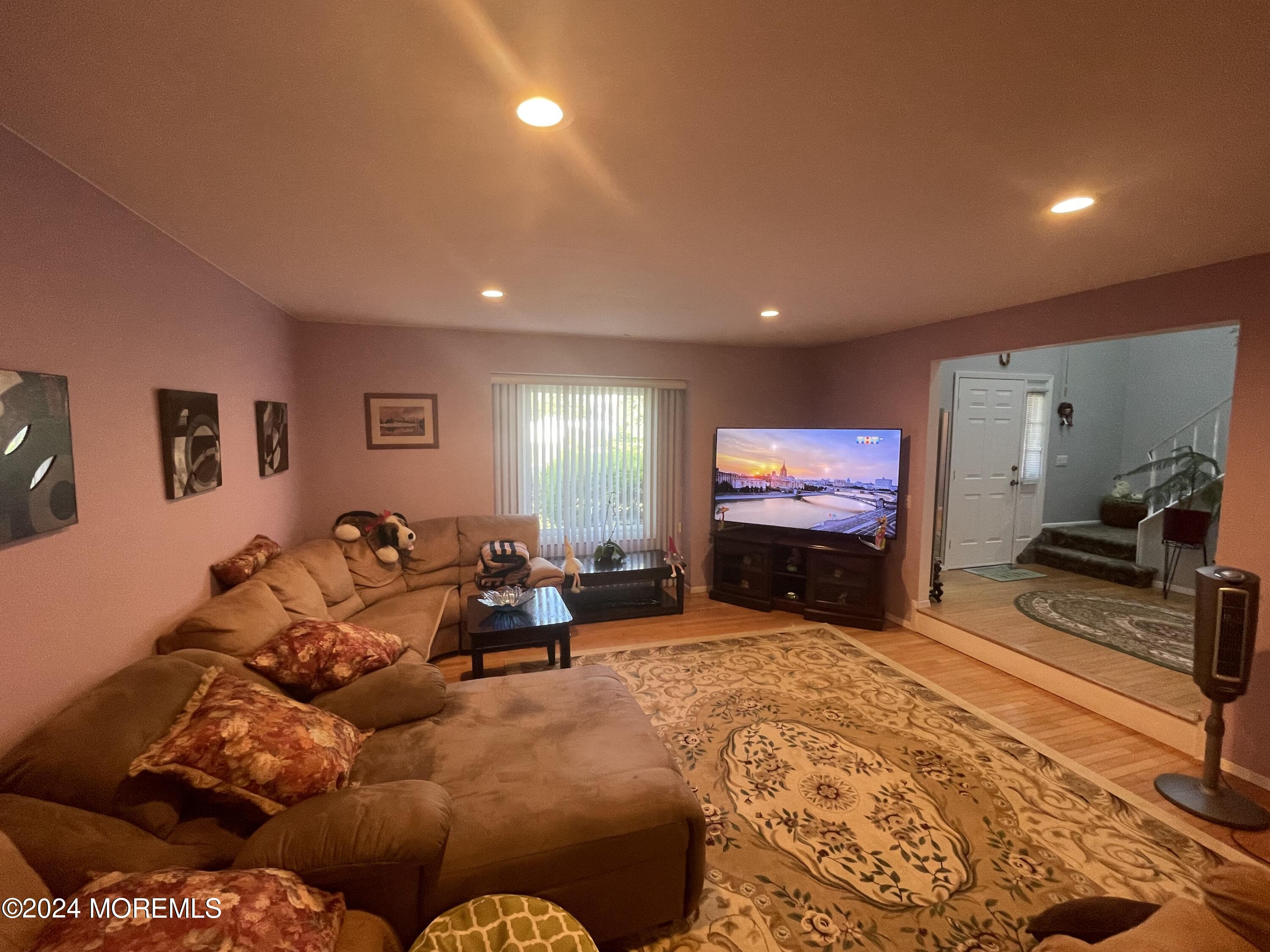 4 Rimwood Lane Howell, NJ 07731 - Photo 17 of 44 a living room with furniture and a flat screen tv