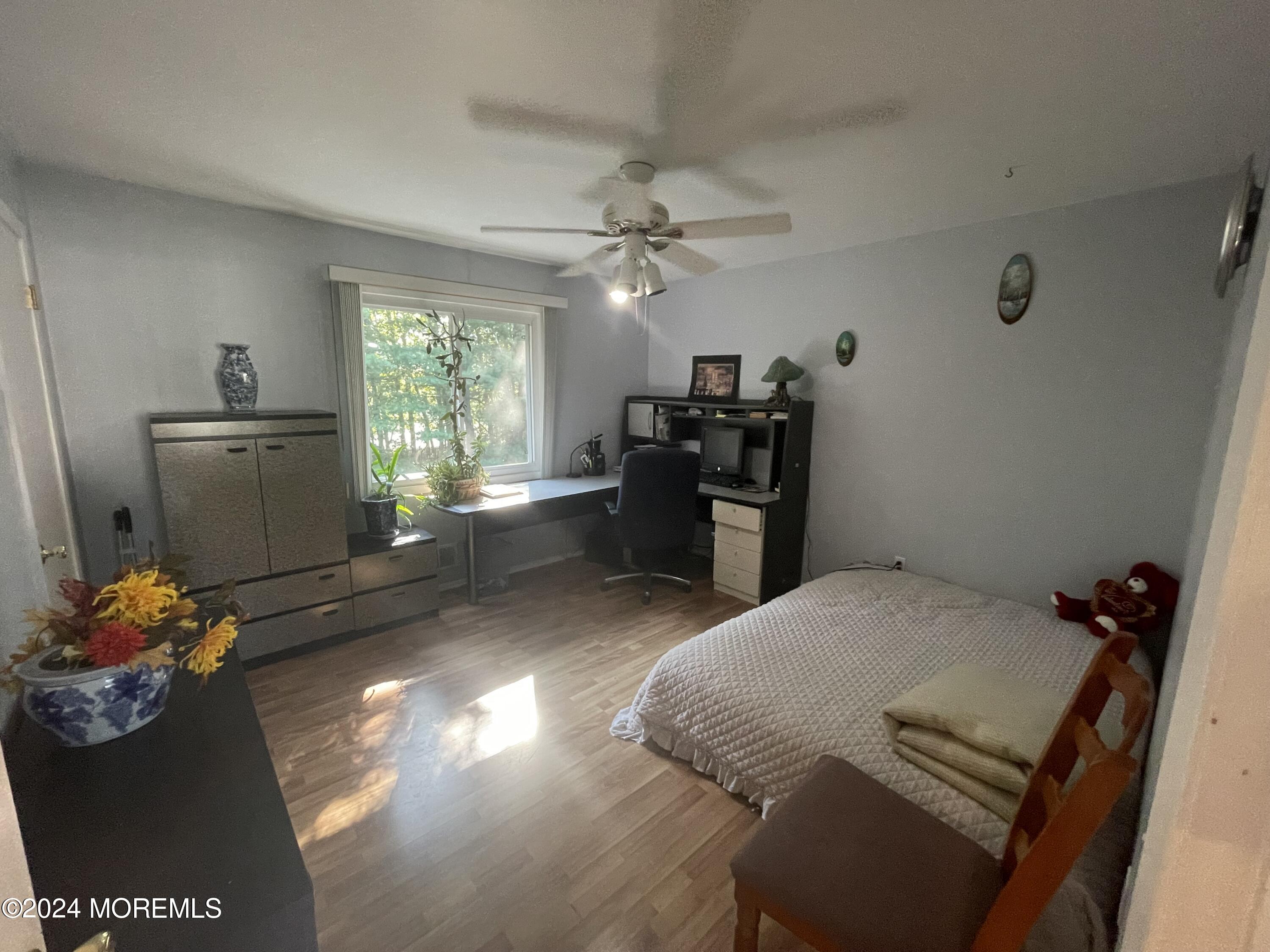 4 Rimwood Lane Howell, NJ 07731 - Photo 30 of 44 a bedroom with a bed and a chandelier