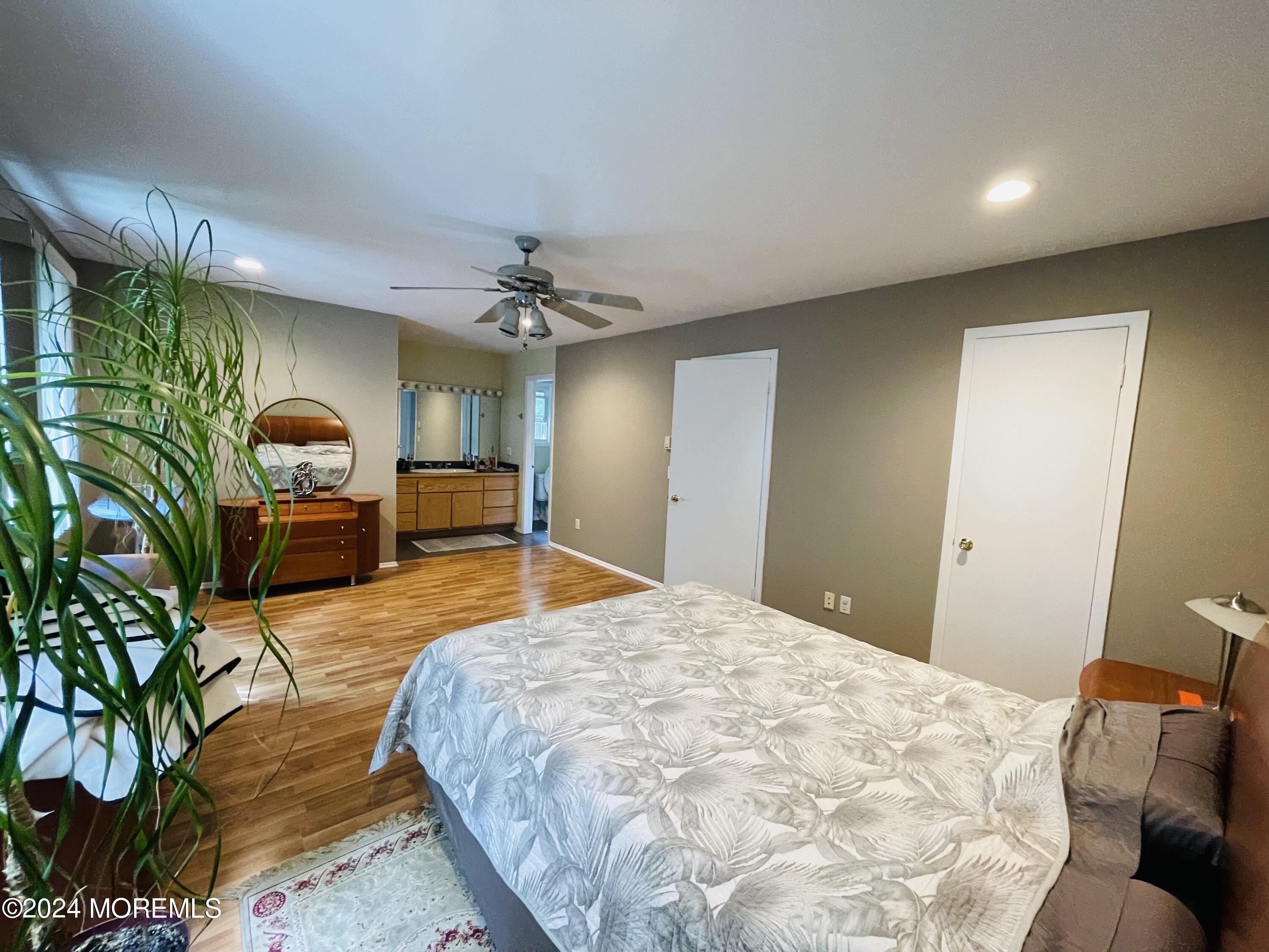 4 Rimwood Lane Howell, NJ 07731 - Photo 42 of 44 a bedroom with a bed and a chandelier