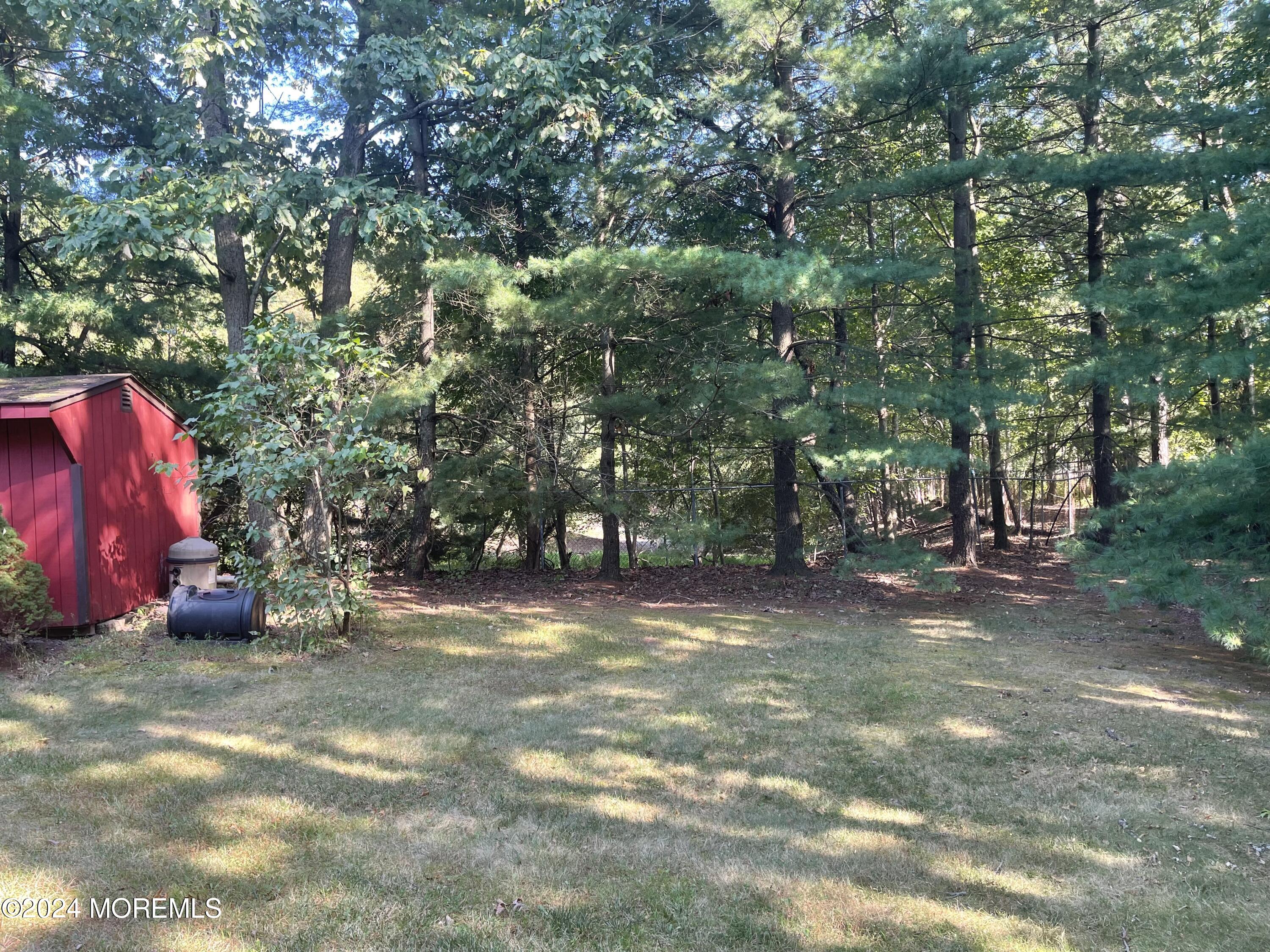 4 Rimwood Lane Howell, NJ 07731 - Photo 8 of 44 a view of a yard with a tree