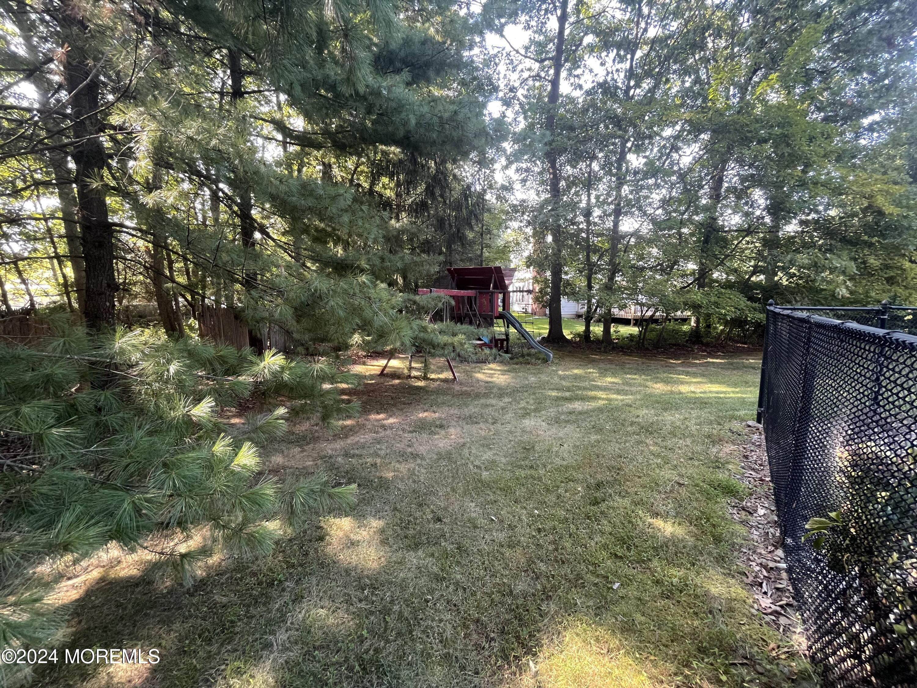 4 Rimwood Lane Howell, NJ 07731 - Photo 9 of 44 a backyard of a house with table and chairs