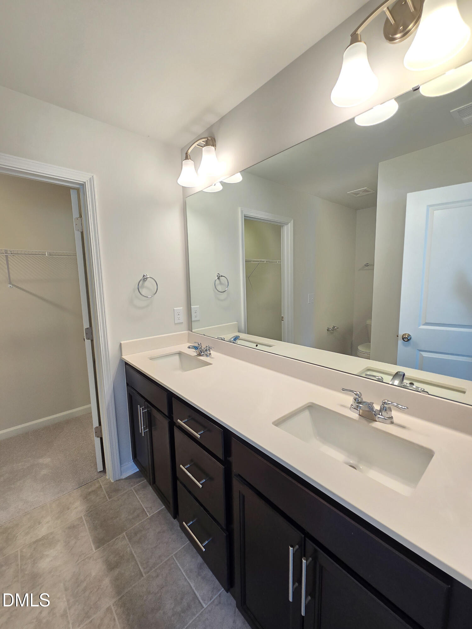 2431 Kasota Lane Raleigh, NC 27610 - Photo 31 of 46 a bathroom with a double vanity sink and a mirror