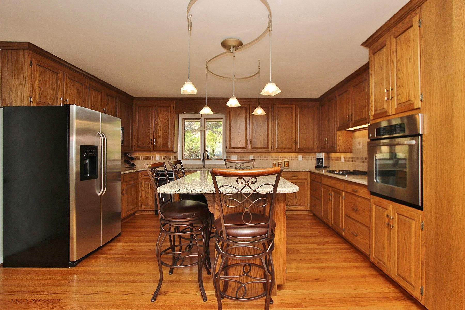 840 Brushy Ridge Road Salem, VA 24153 - Photo 35 of 86 a kitchen with stainless steel appliances kitchen island granite countertop a refrigerator a stove a sink dishwasher a dining table and chairs with wooden floor