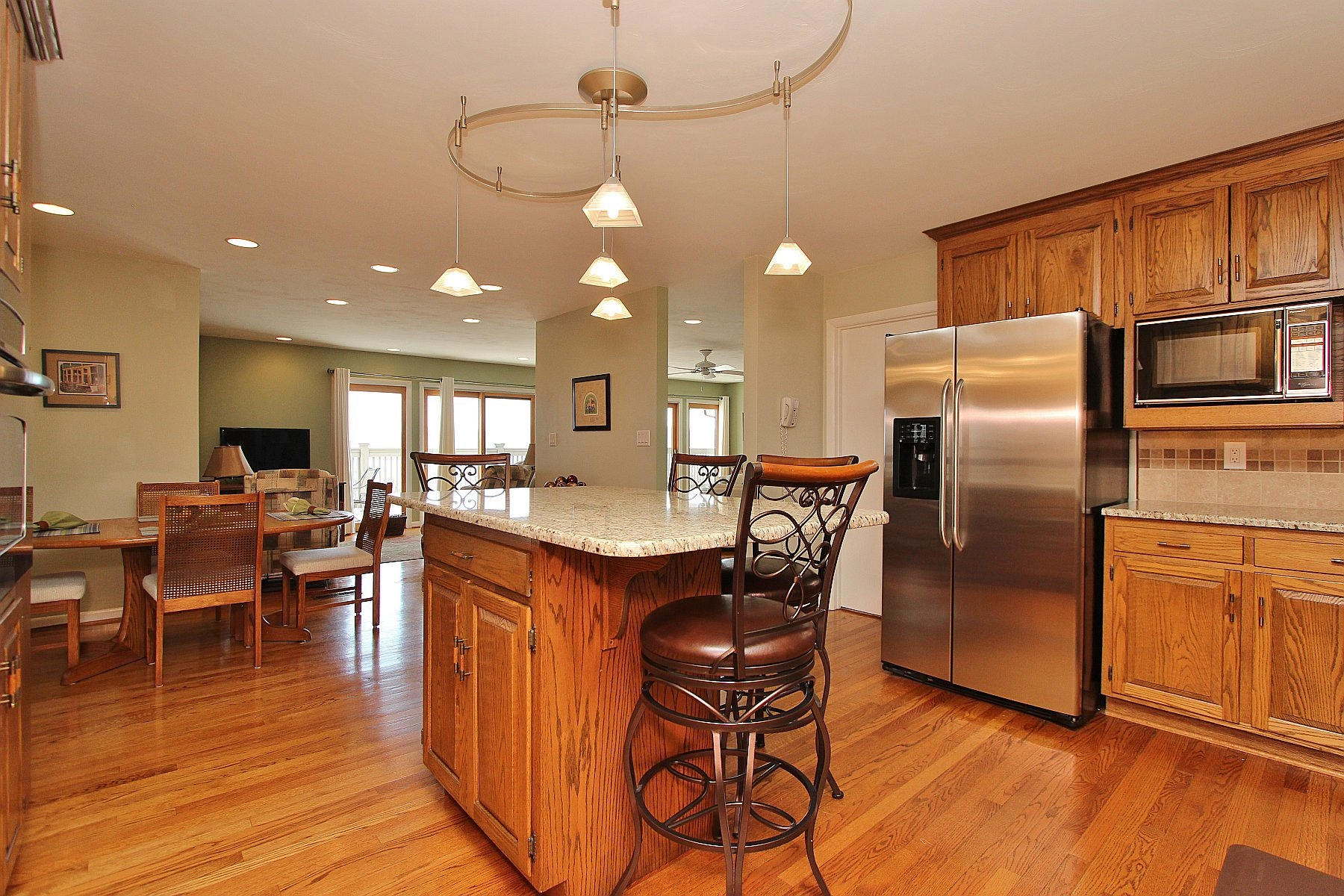 840 Brushy Ridge Road Salem, VA 24153 - Photo 37 of 86 a kitchen with stainless steel appliances granite countertop a refrigerator a stove a sink a dining table and chairs with wooden floor