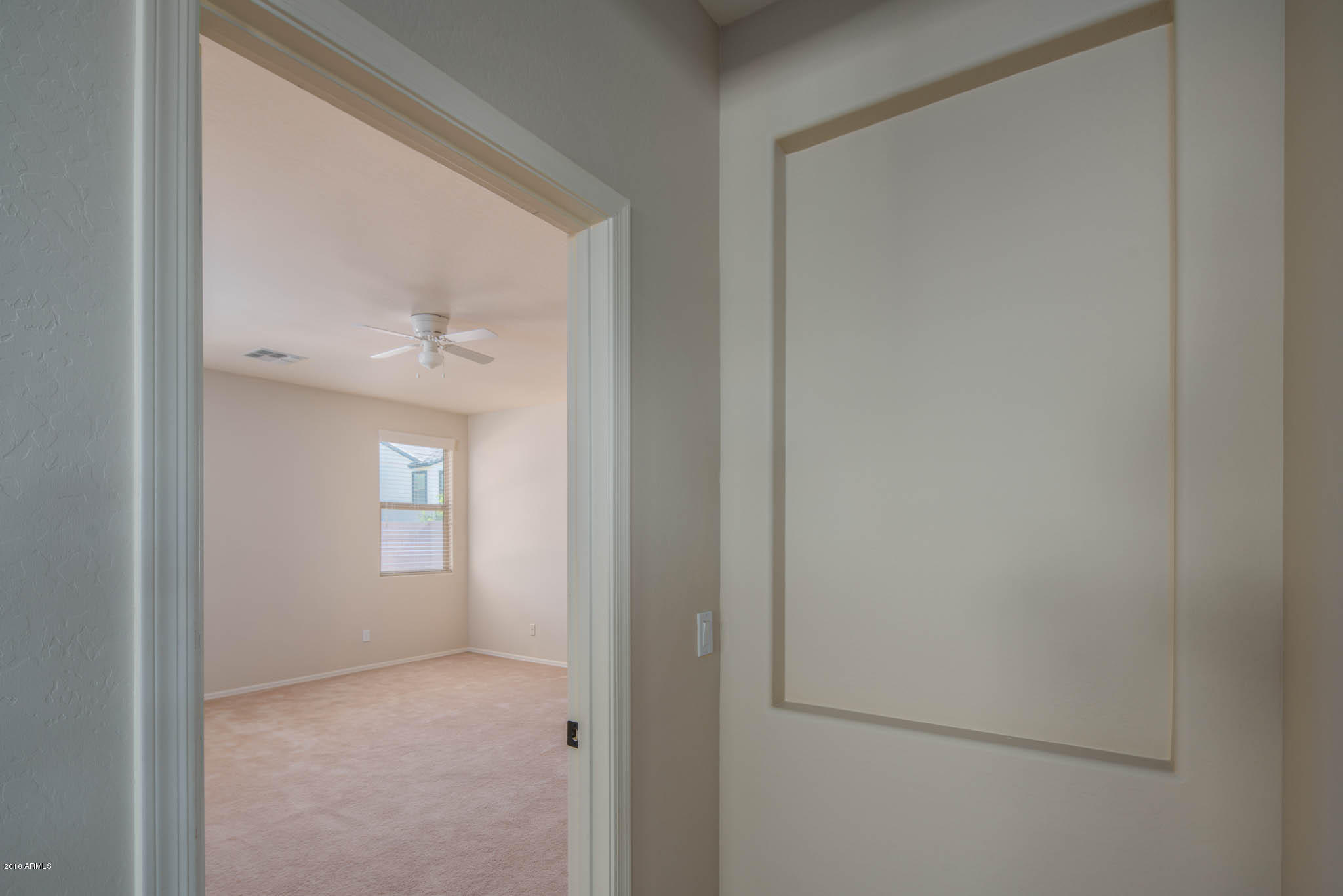 7863 West Redbird Road Peoria, AZ 85383 - Photo 17 of 43 a view of an empty room with windows and closet