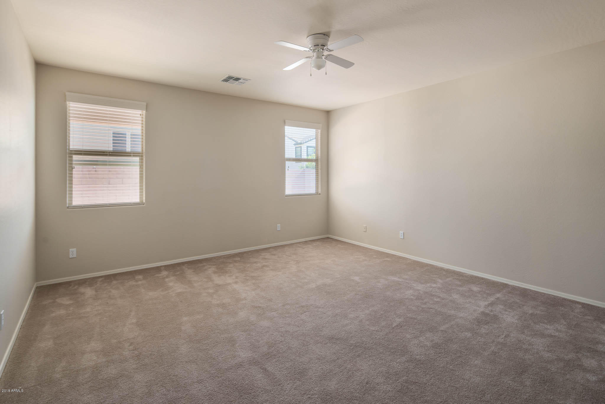 7863 West Redbird Road Peoria, AZ 85383 - Photo 18 of 43 an empty room with a window and ceiling fan