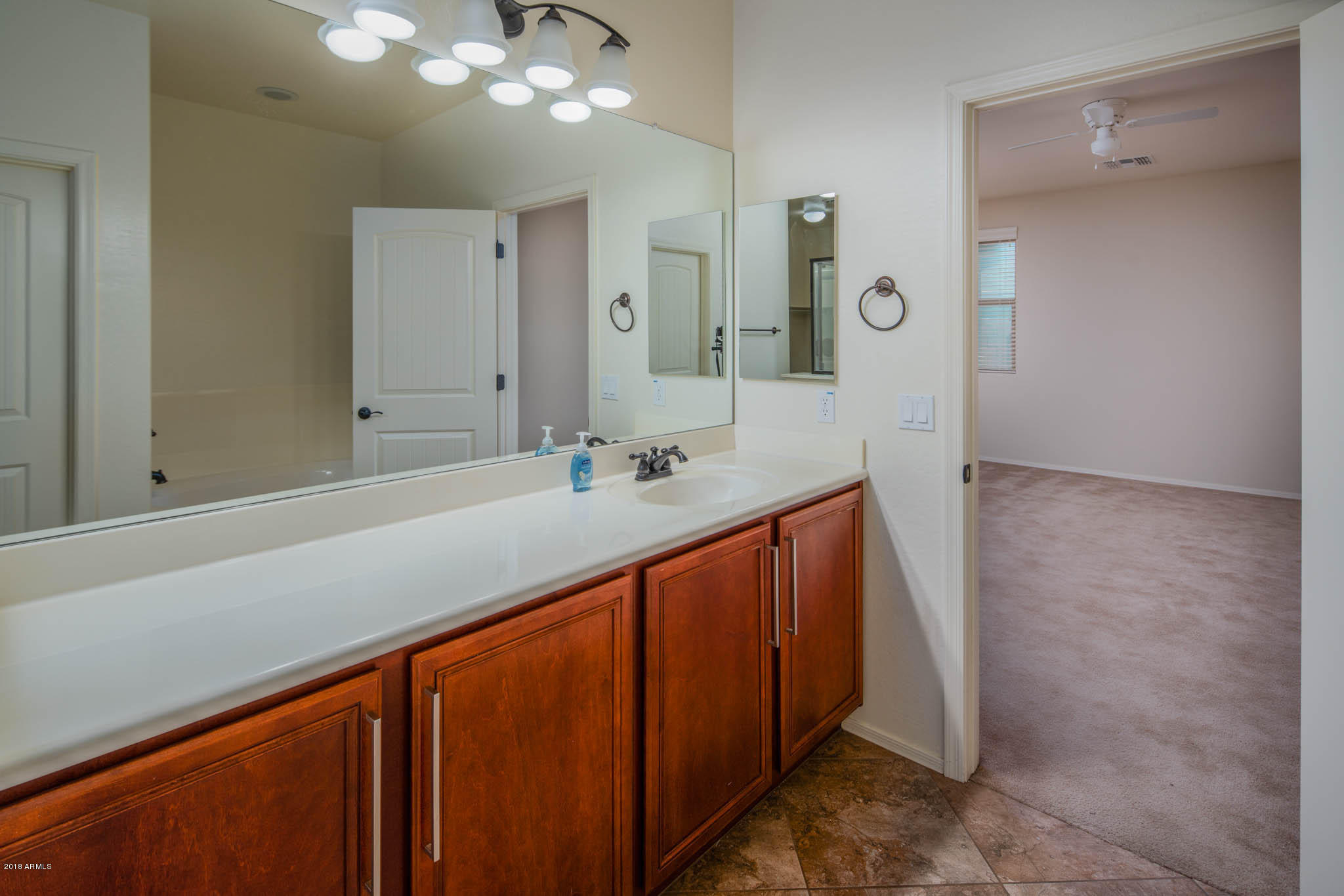 7863 West Redbird Road Peoria, AZ 85383 - Photo 20 of 43 a bathroom with a sink and a mirror
