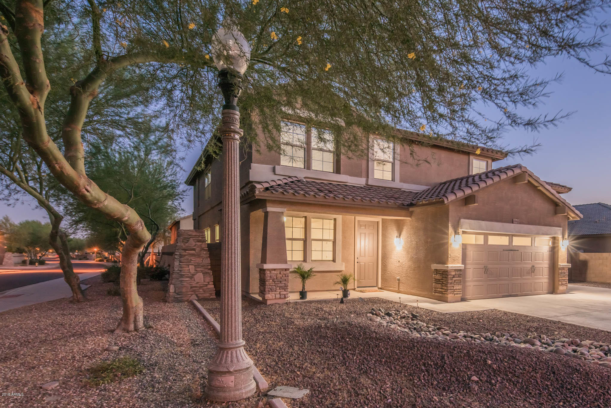 7863 West Redbird Road Peoria, AZ 85383 - Photo 2 of 43 a view of a house with a yard