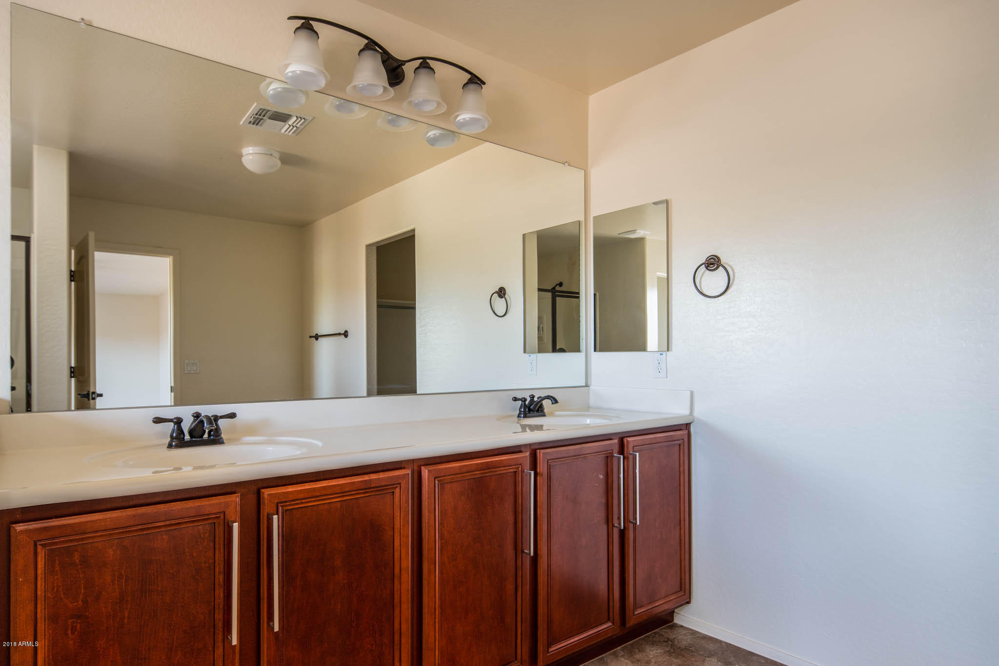 7863 West Redbird Road Peoria, AZ 85383 - Photo 27 of 43 a bathroom with a double vanity sink and a mirror