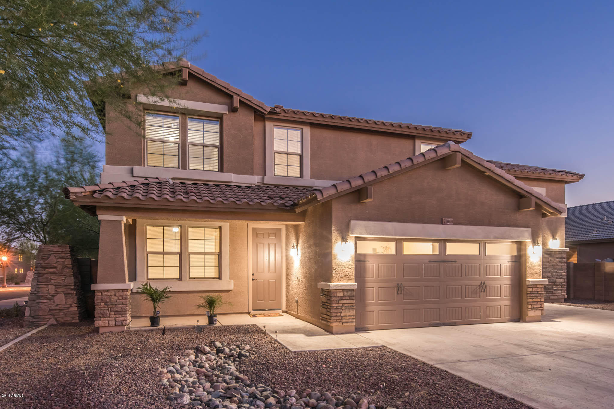 7863 West Redbird Road Peoria, AZ 85383 - Photo 3 of 43 a front view of a house with a garden