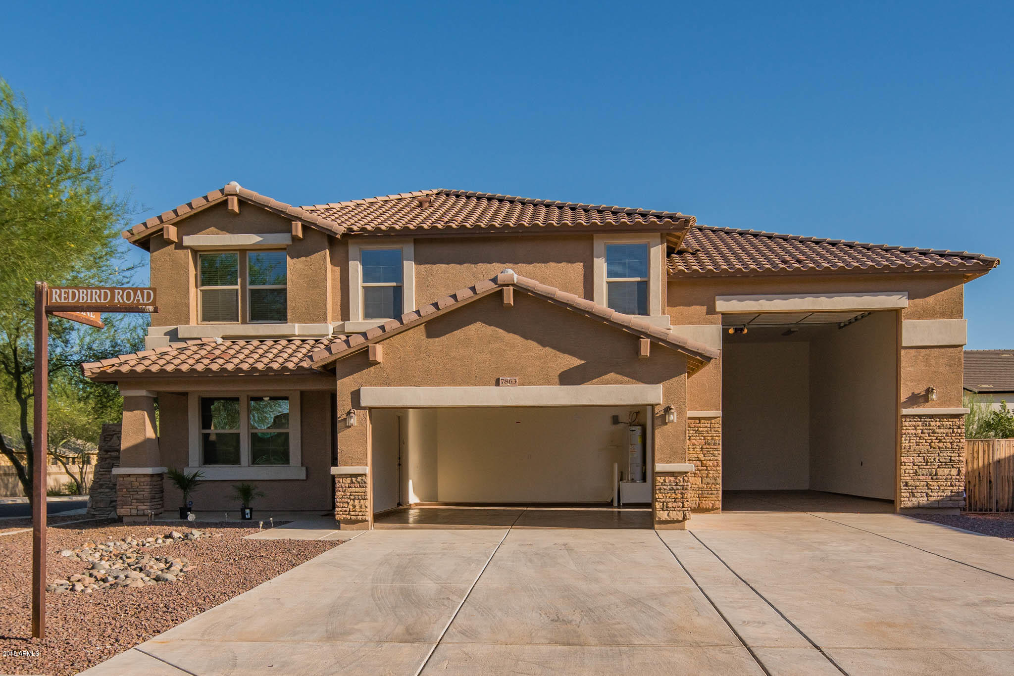 7863 West Redbird Road Peoria, AZ 85383 - Photo 34 of 43 a front view of a house with a garage