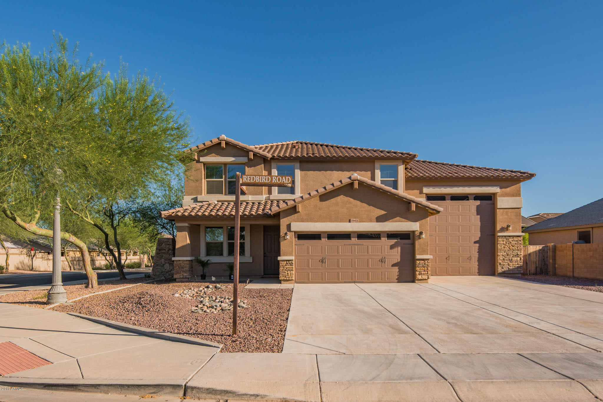 7863 West Redbird Road Peoria, AZ 85383 - Photo 36 of 43 a front view of a house with garden