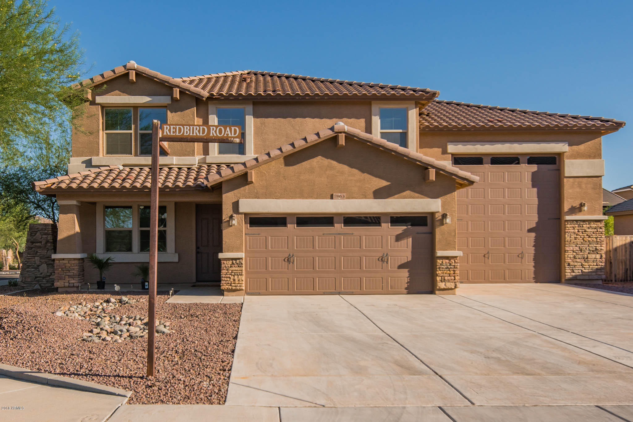 7863 West Redbird Road Peoria, AZ 85383 - Photo 37 of 43 a front view of a house with garden
