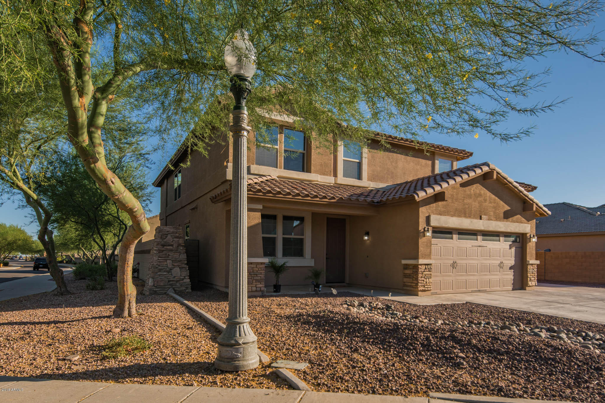 7863 West Redbird Road Peoria, AZ 85383 - Photo 38 of 43 a front view of a house with a yard