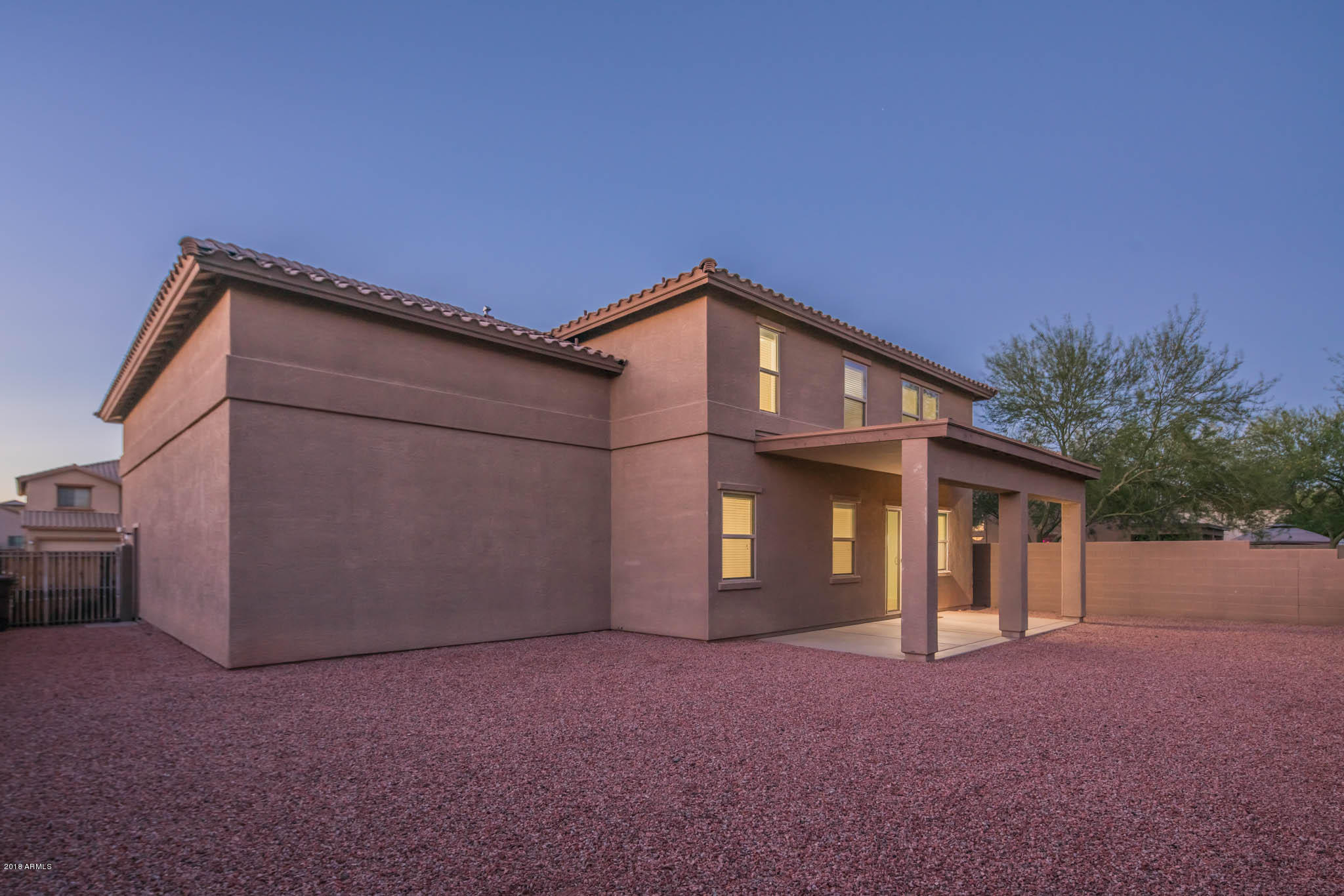 7863 West Redbird Road Peoria, AZ 85383 - Photo 42 of 43 a front view of a house with a yard and garage