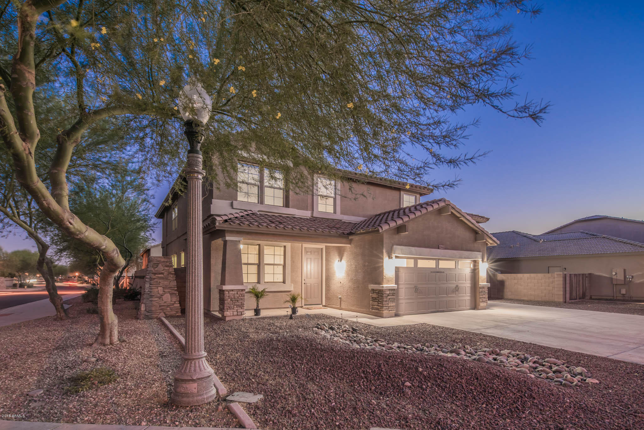 7863 West Redbird Road Peoria, AZ 85383 - Photo 5 of 43 a front view of a house with a yard and garage