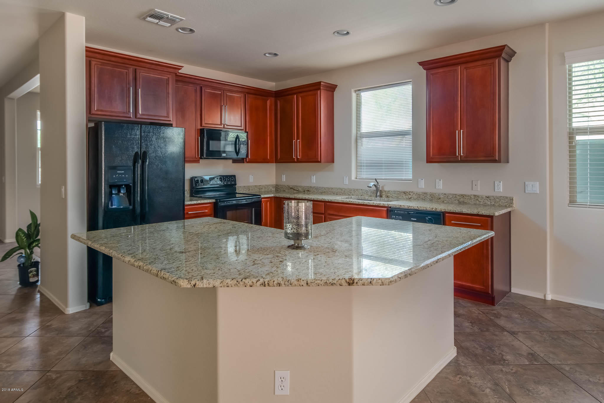 7863 West Redbird Road Peoria, AZ 85383 - Photo 7 of 43 a kitchen with stainless steel appliances granite countertop a sink a stove and a refrigerator