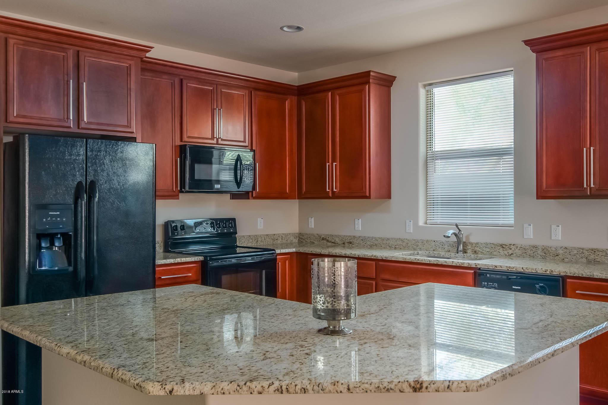 7863 West Redbird Road Peoria, AZ 85383 - Photo 9 of 43 a kitchen with stainless steel appliances granite countertop a sink a microwave counter space and cabinets