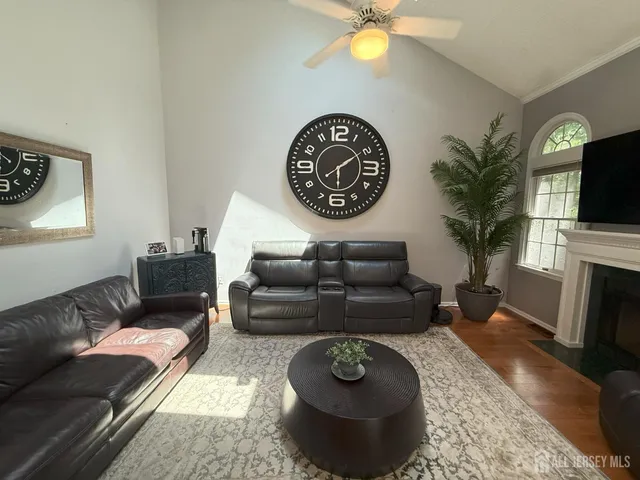 a living room with furniture a fireplace and a flat screen tv