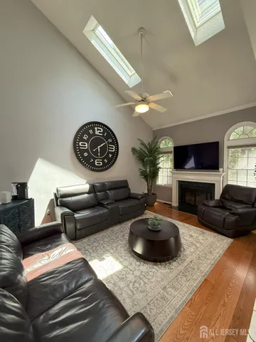 a living room with furniture a flat screen tv and a fireplace