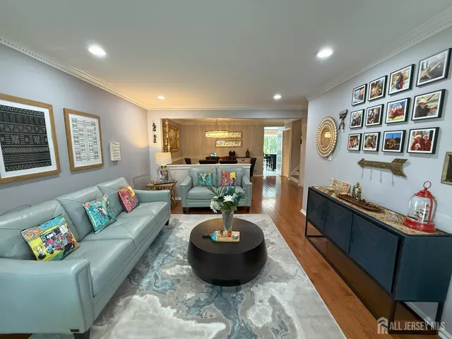 a living room with furniture and painting on the wall