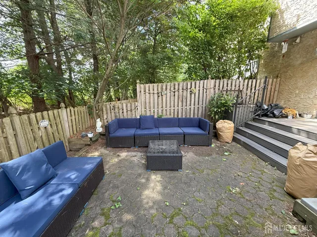 a view of a yard with a bench in the patio