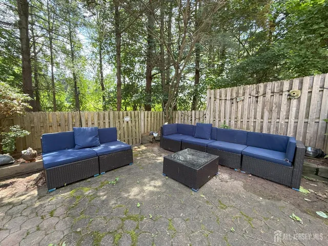 a view of a house with a yard and sitting area