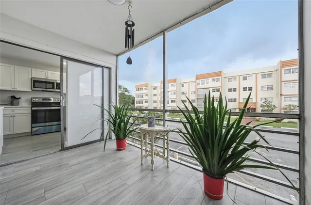 a view of a living room with furniture and a potted plant