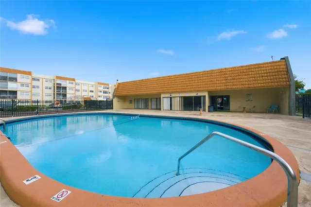a view of a swimming pool with a lawn chairs