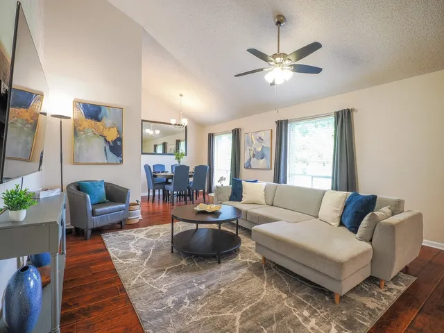 a living room with furniture and a large window