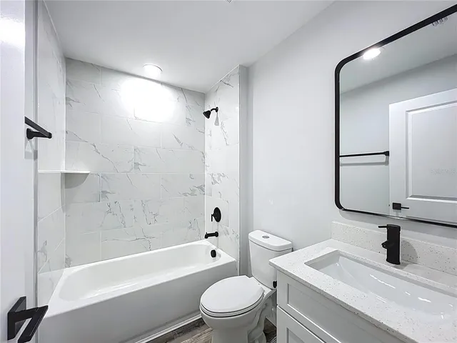 a view of a bathroom with a sink and mirror