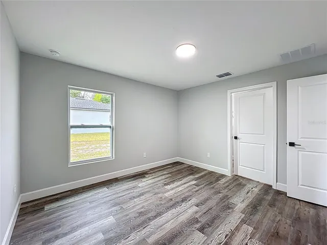 a view of room with window and hardwood floor