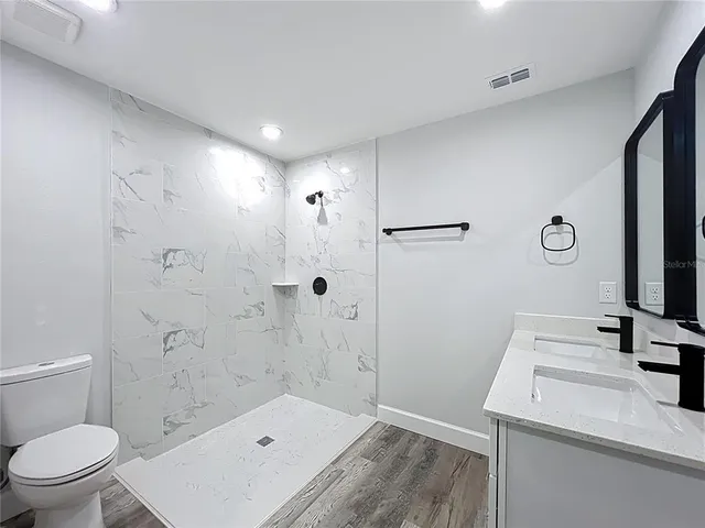 a bathroom with a granite countertop sink mirror and vanity