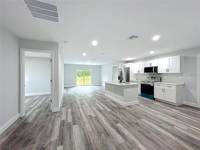 a view of kitchen with cabinets and wooden floor