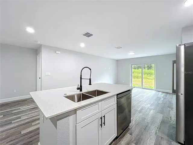 a kitchen with a sink and chandelier
