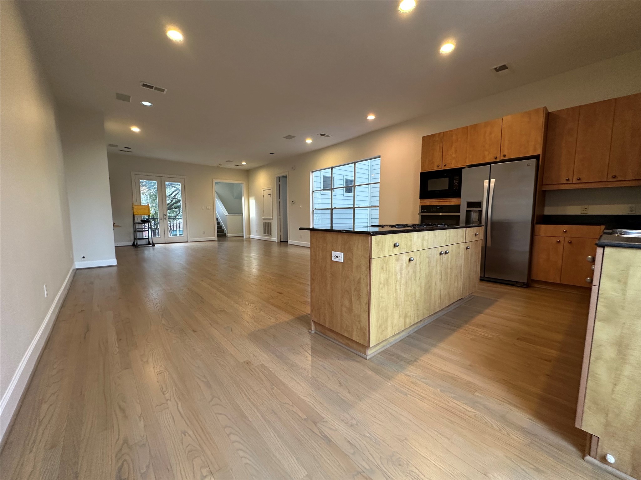 2713 Crawford Street Houston, TX 77004 - Photo 12 of 27 a large kitchen with stainless steel appliances lots of counter space and wooden floor