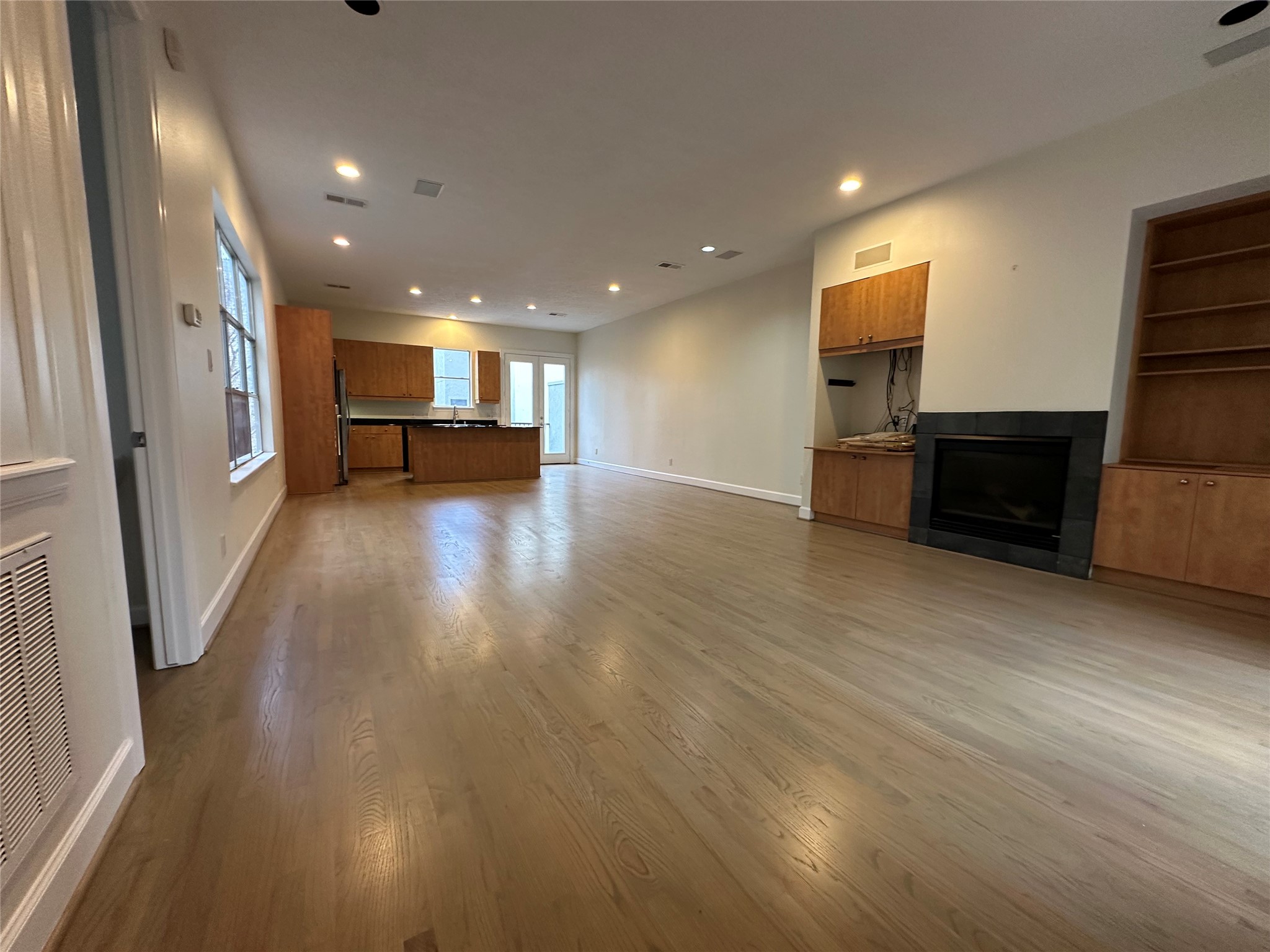 2713 Crawford Street Houston, TX 77004 - Photo 14 of 27 an empty room with wooden floor and furniture