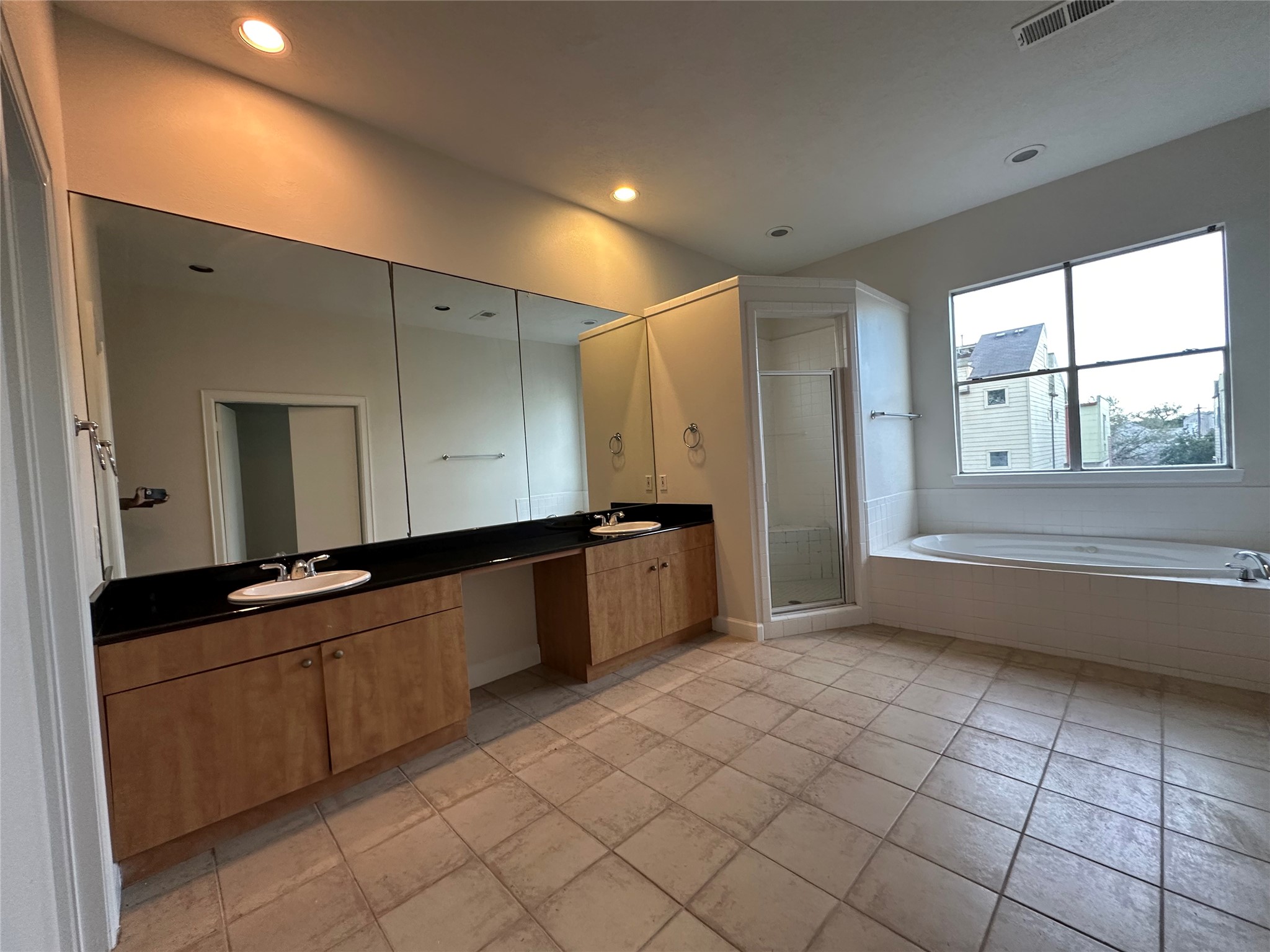 2713 Crawford Street Houston, TX 77004 - Photo 23 of 27 a large kitchen with kitchen island a sink a counter and a large window