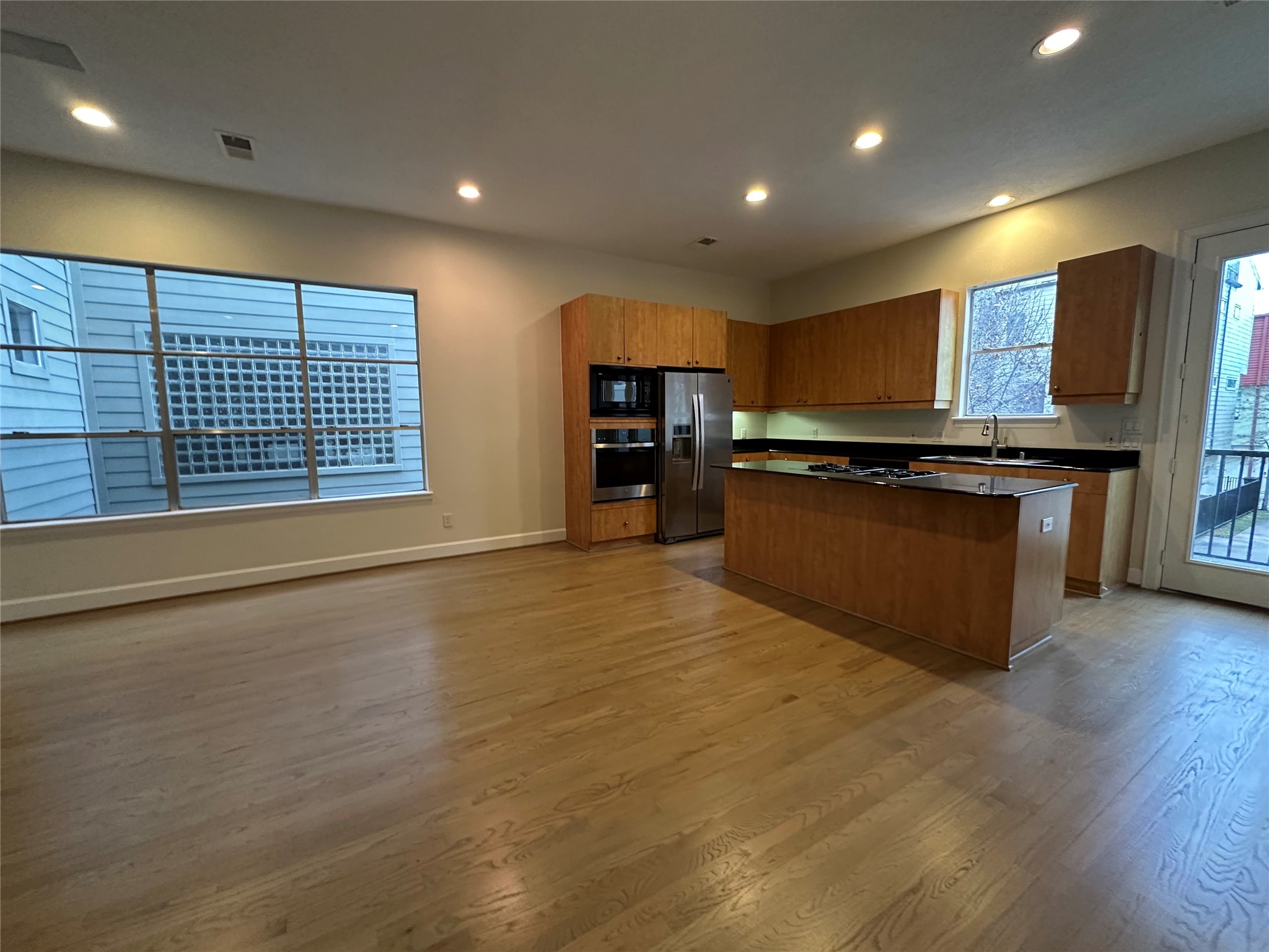 2713 Crawford Street Houston, TX 77004 - Photo 6 of 27 a large kitchen with stainless steel appliances granite countertop a stove and a wooden cabinets