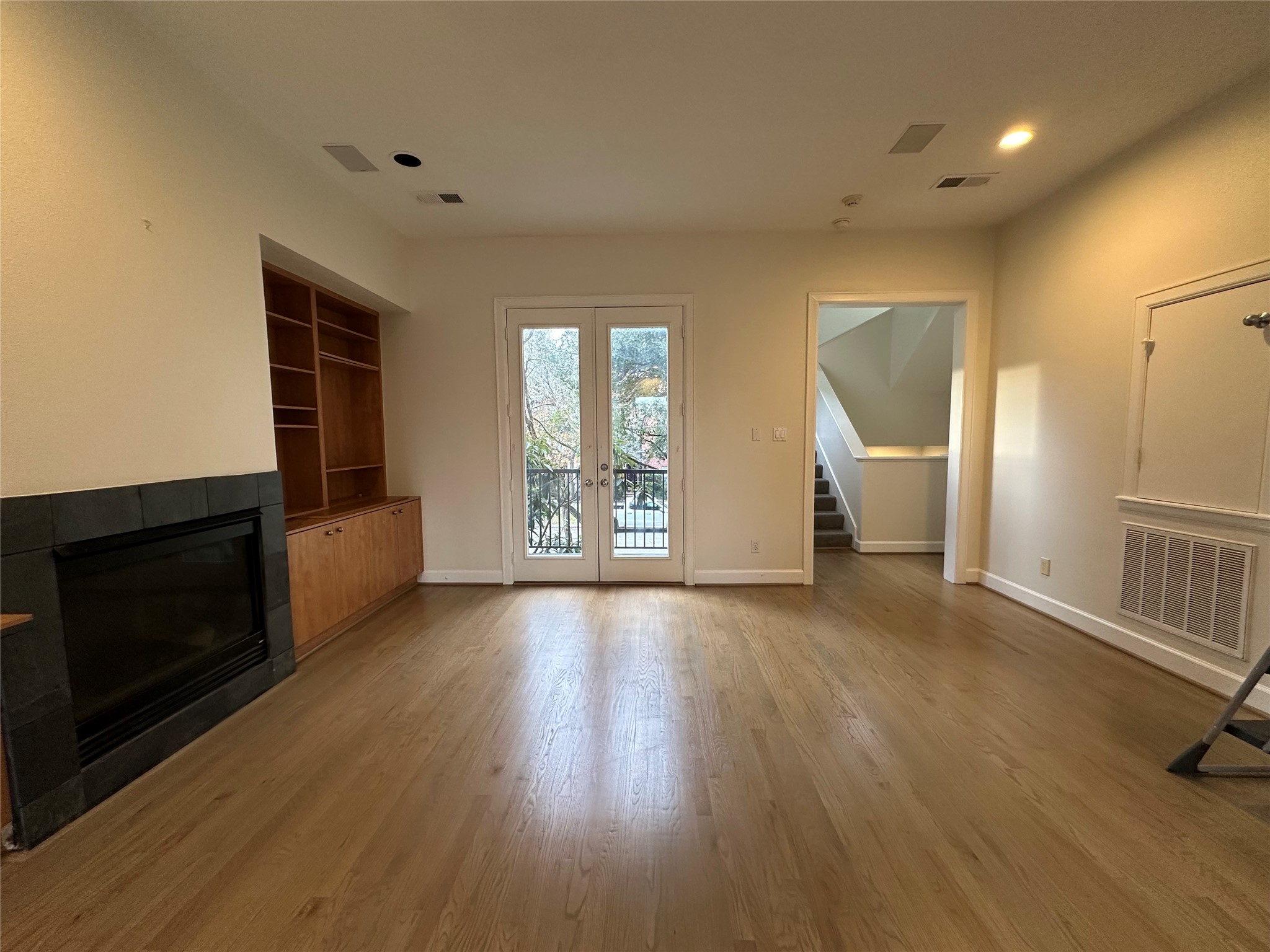 2713 Crawford Street Houston, TX 77004 - Photo 7 of 27 an empty room with wooden floor and windows