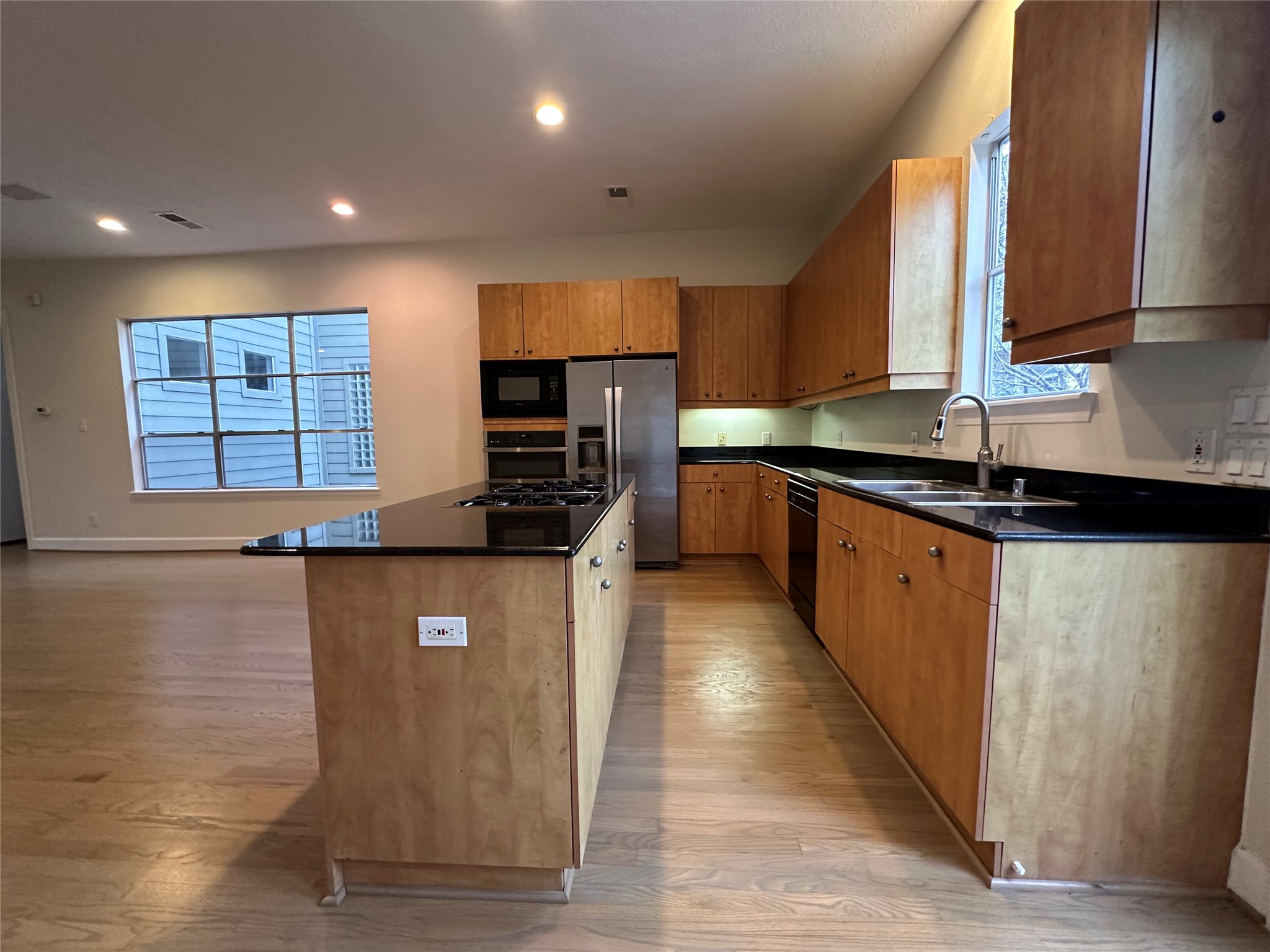 2713 Crawford Street Houston, TX 77004 - Photo 9 of 27 a kitchen with stainless steel appliances granite countertop a sink a stove and a refrigerator