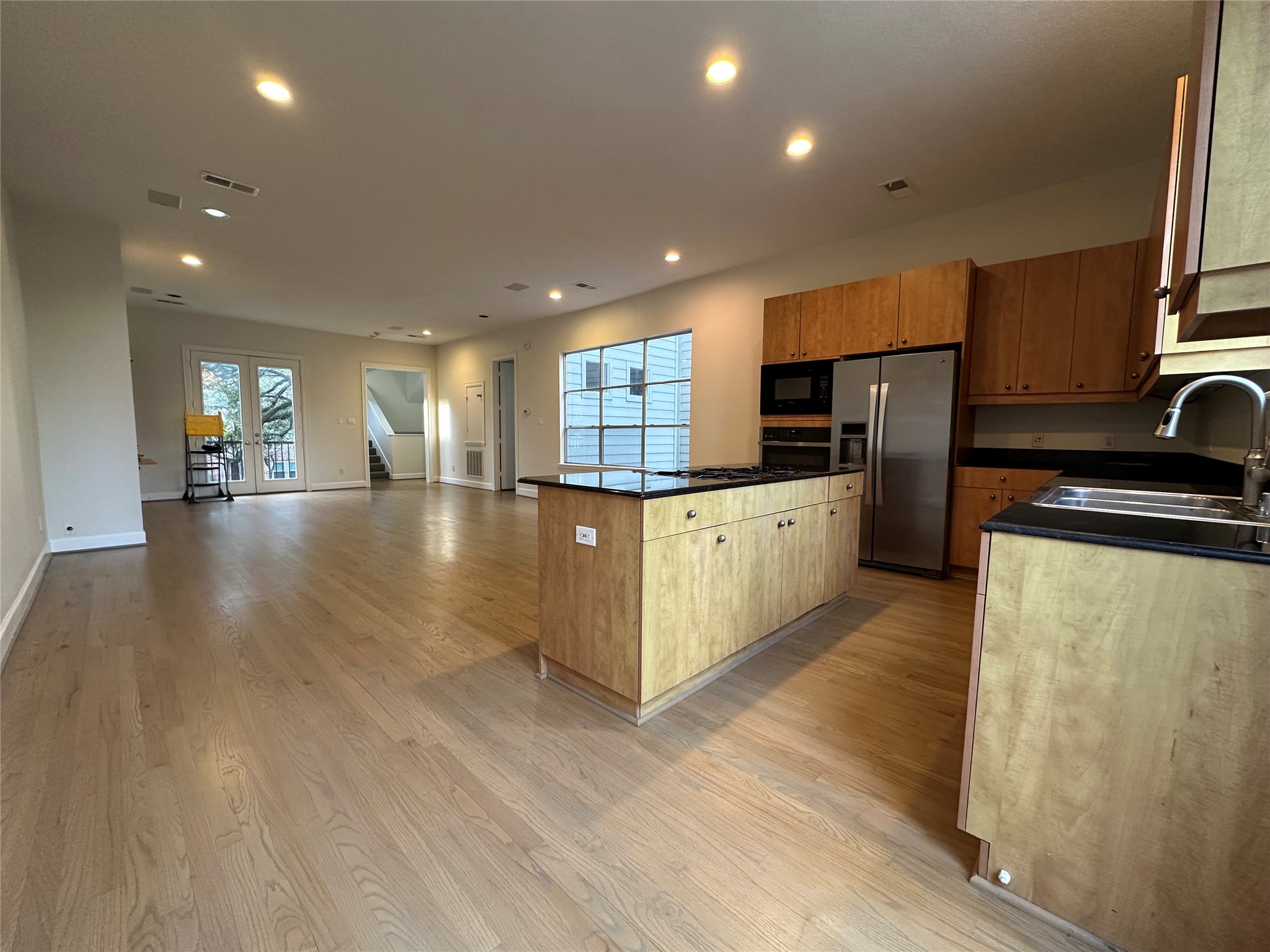 2713 Crawford Street Houston, TX 77004 - Photo 10 of 27 a large kitchen with stainless steel appliances granite countertop a large counter top a sink and a refrigerator