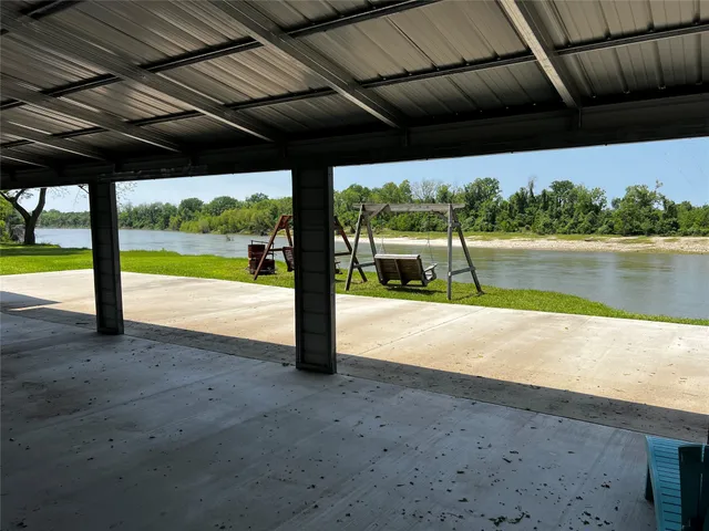 a view of a kitchen with a table and chairs in front of it