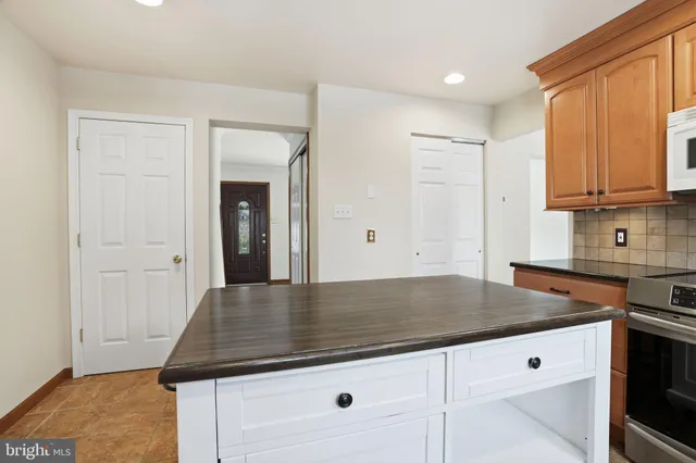 a kitchen with granite countertop a sink cabinets and wooden floor